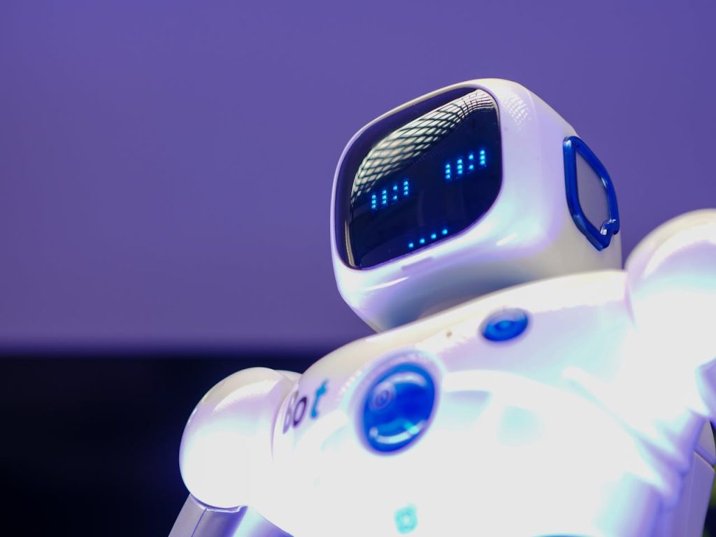 A modern humanoid robot with digital face and luminescent screen, symbolizing innovation in technology.
